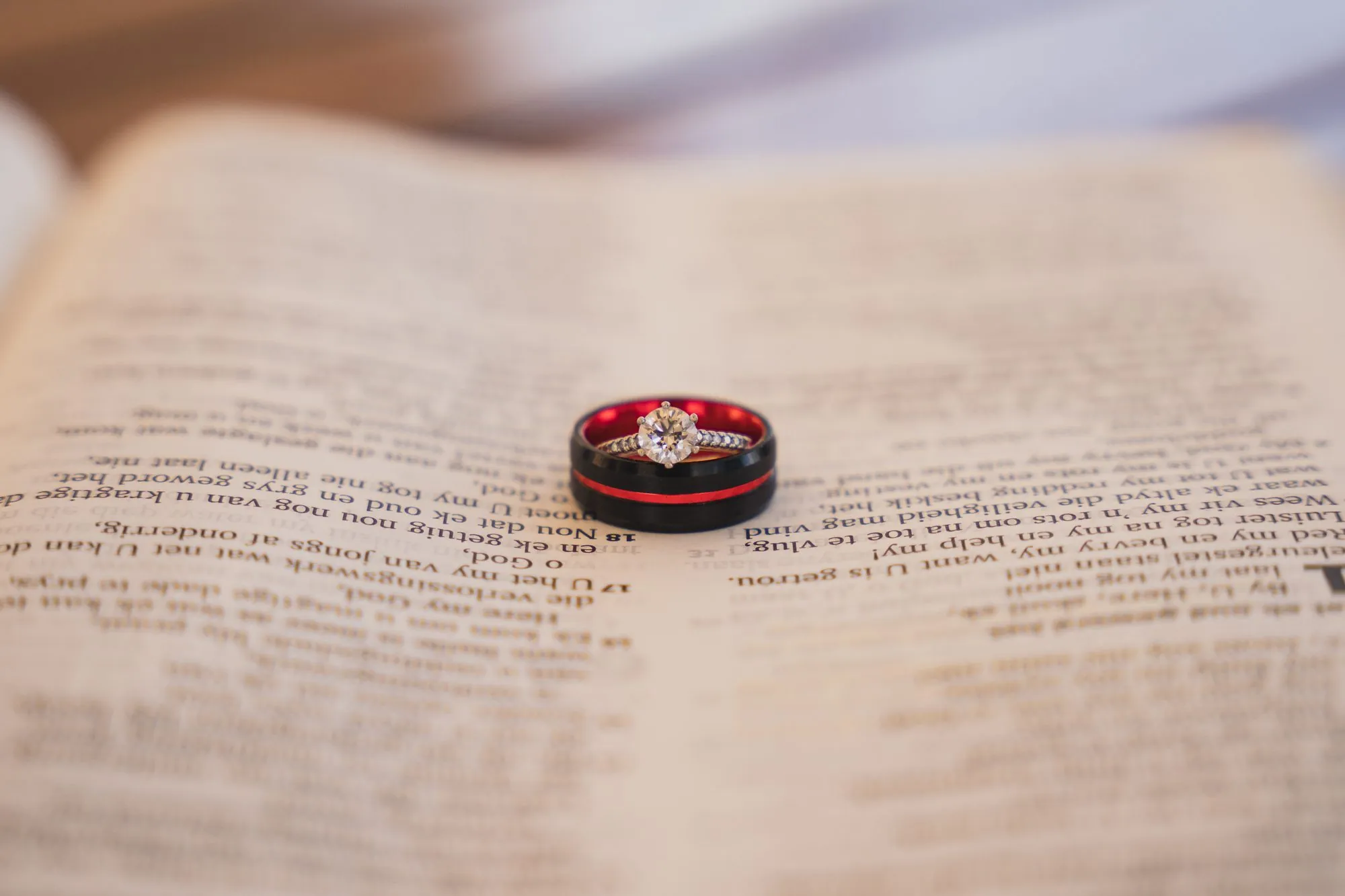 Wedding rings resting on an open Bible