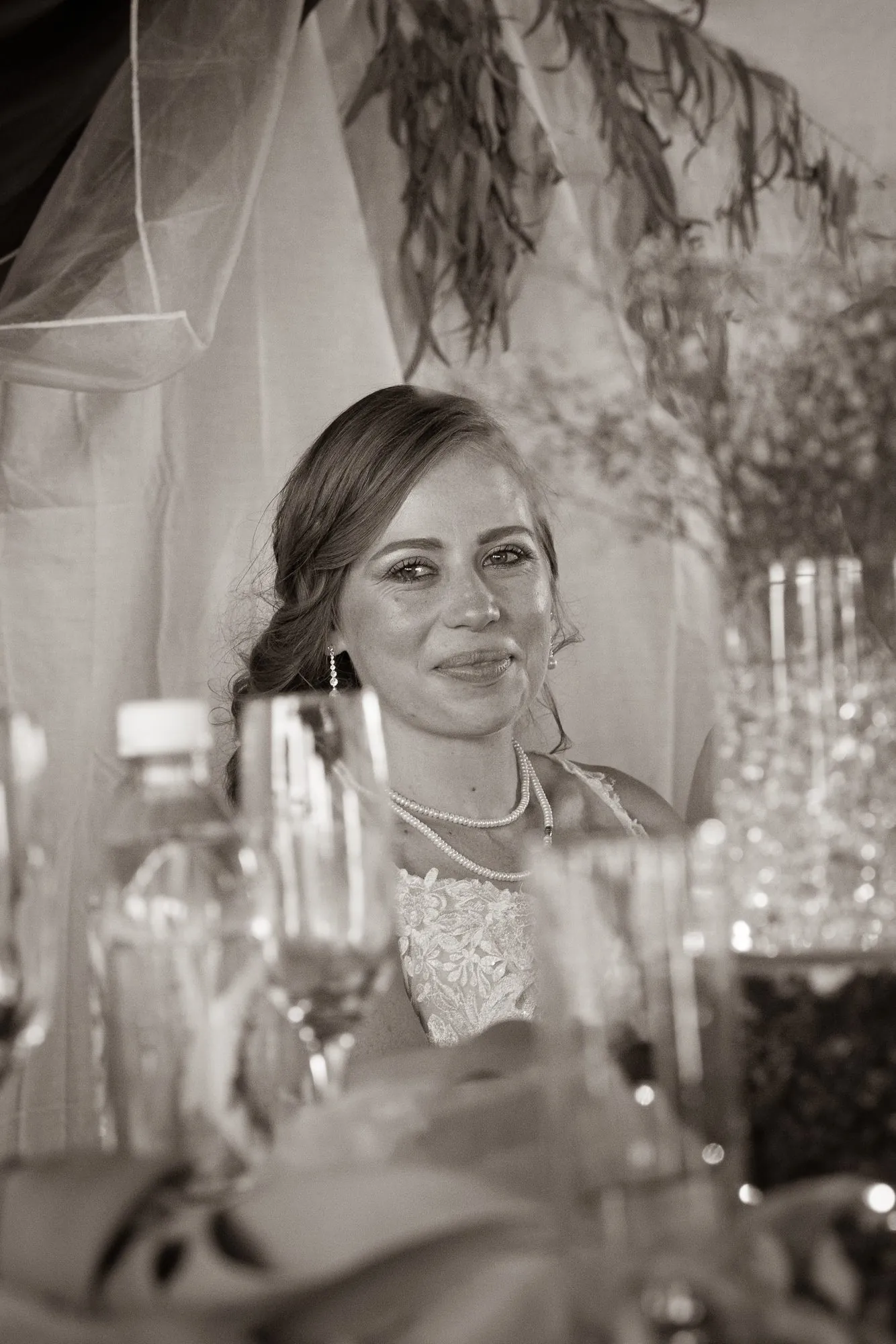 The bride at the reception table, in black and white