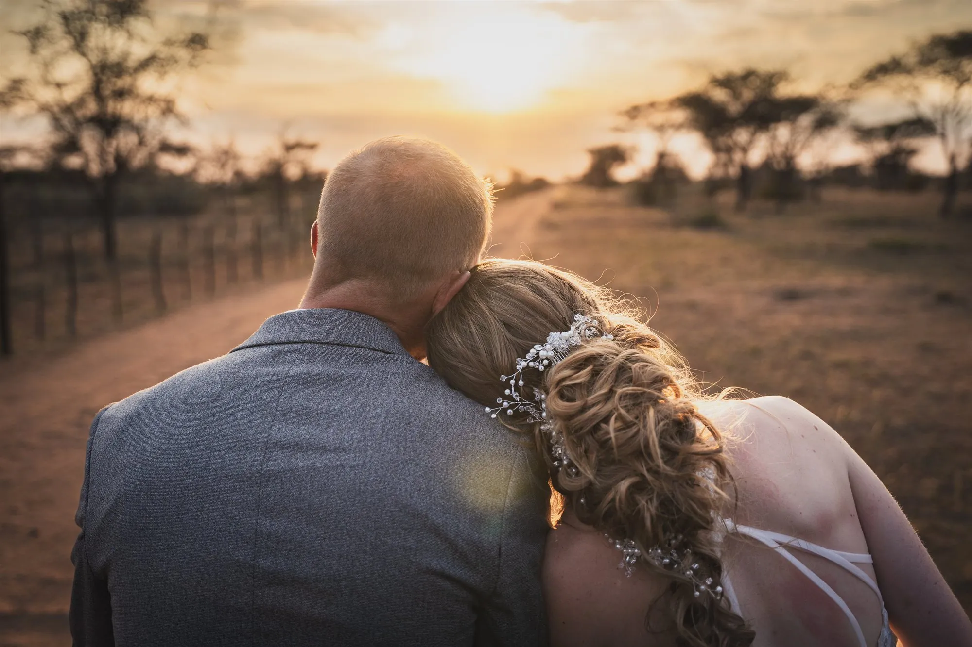 A wedding couple watching the sunset