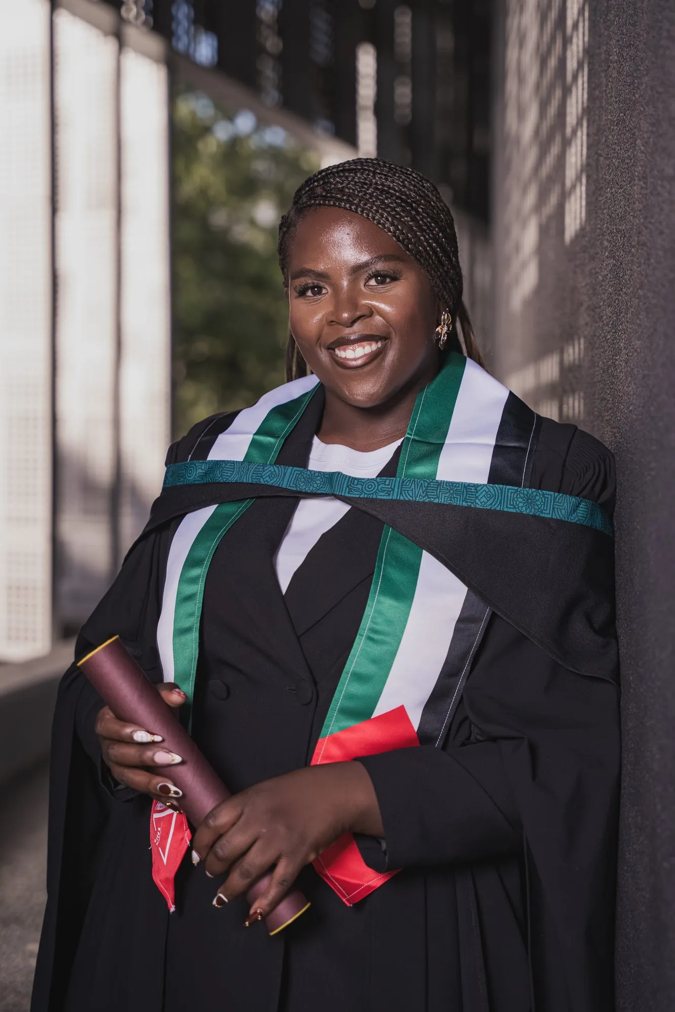 Graduate in her gown holding her scroll
