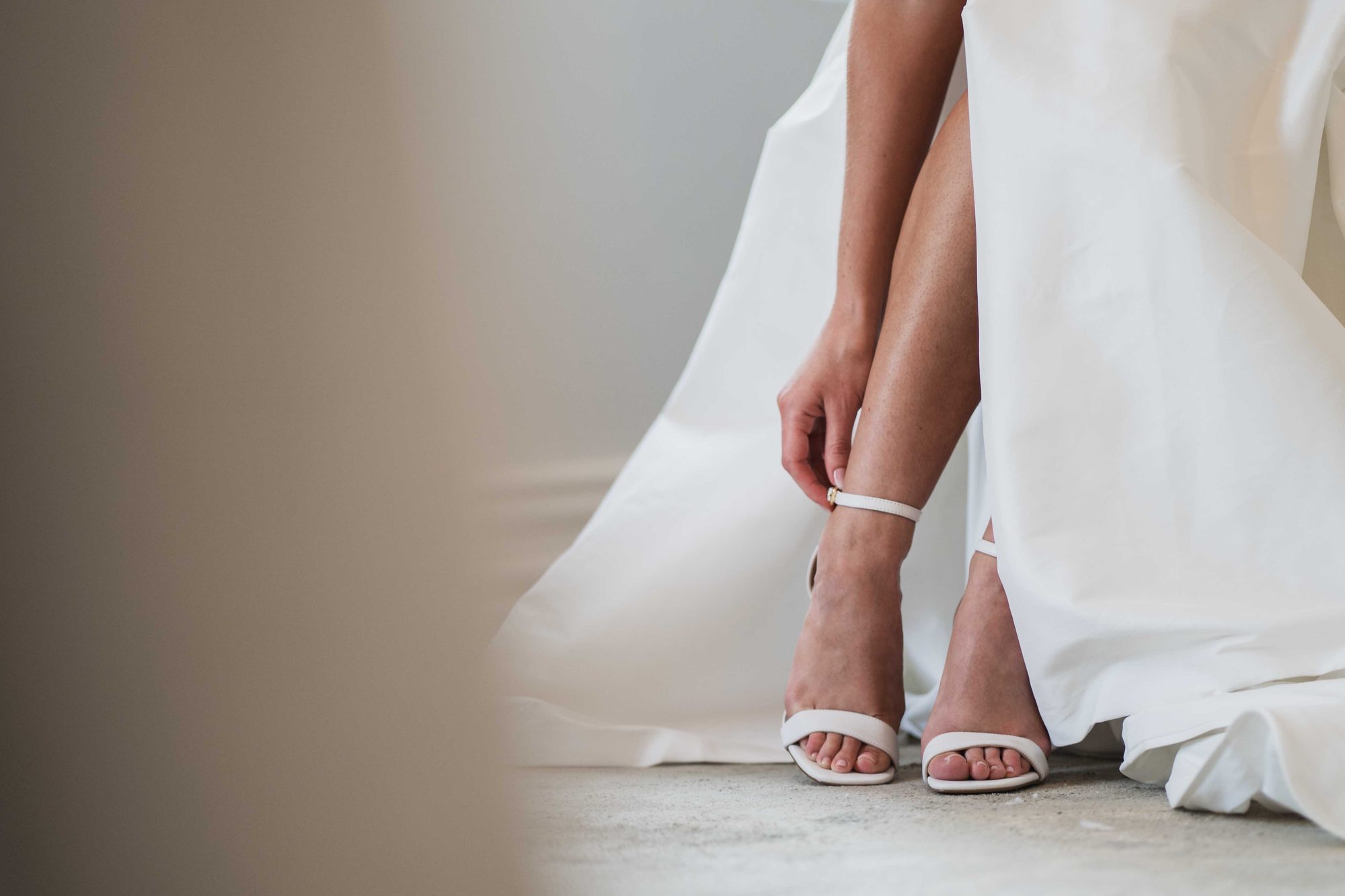 Bridal shoes and the hem of the gown