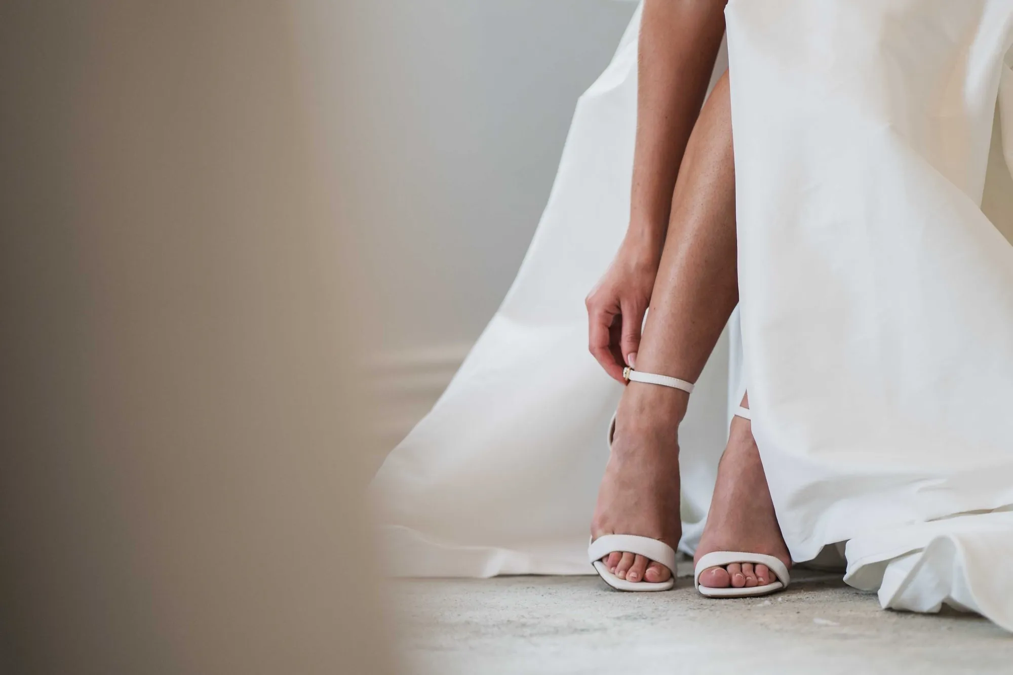 Bridal shoes and the hem of the gown
