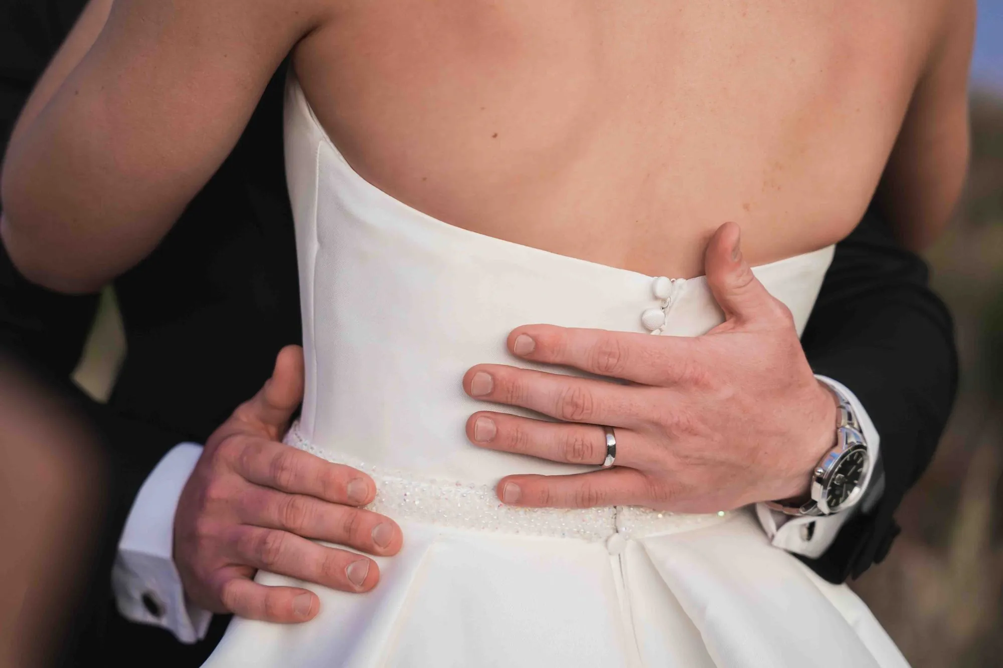 A bride and groom in a close embrace